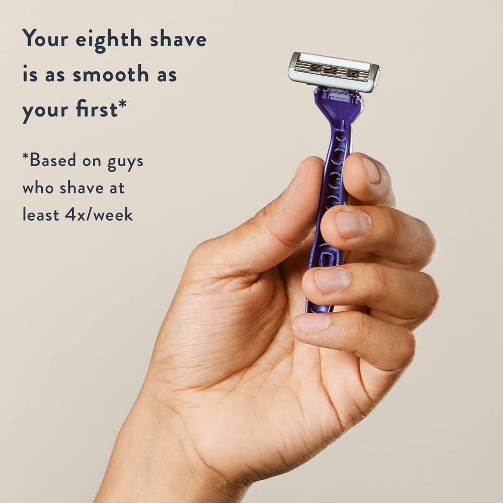 Hand holding a Harry's Disposable Razor, showcasing the smooth shave promise for men. Original packaging displayed.