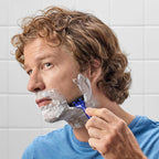 A man using Harry's Disposable Razors for Men in a bathroom setting, showcasing a smooth shave. Verified by CuratCart.