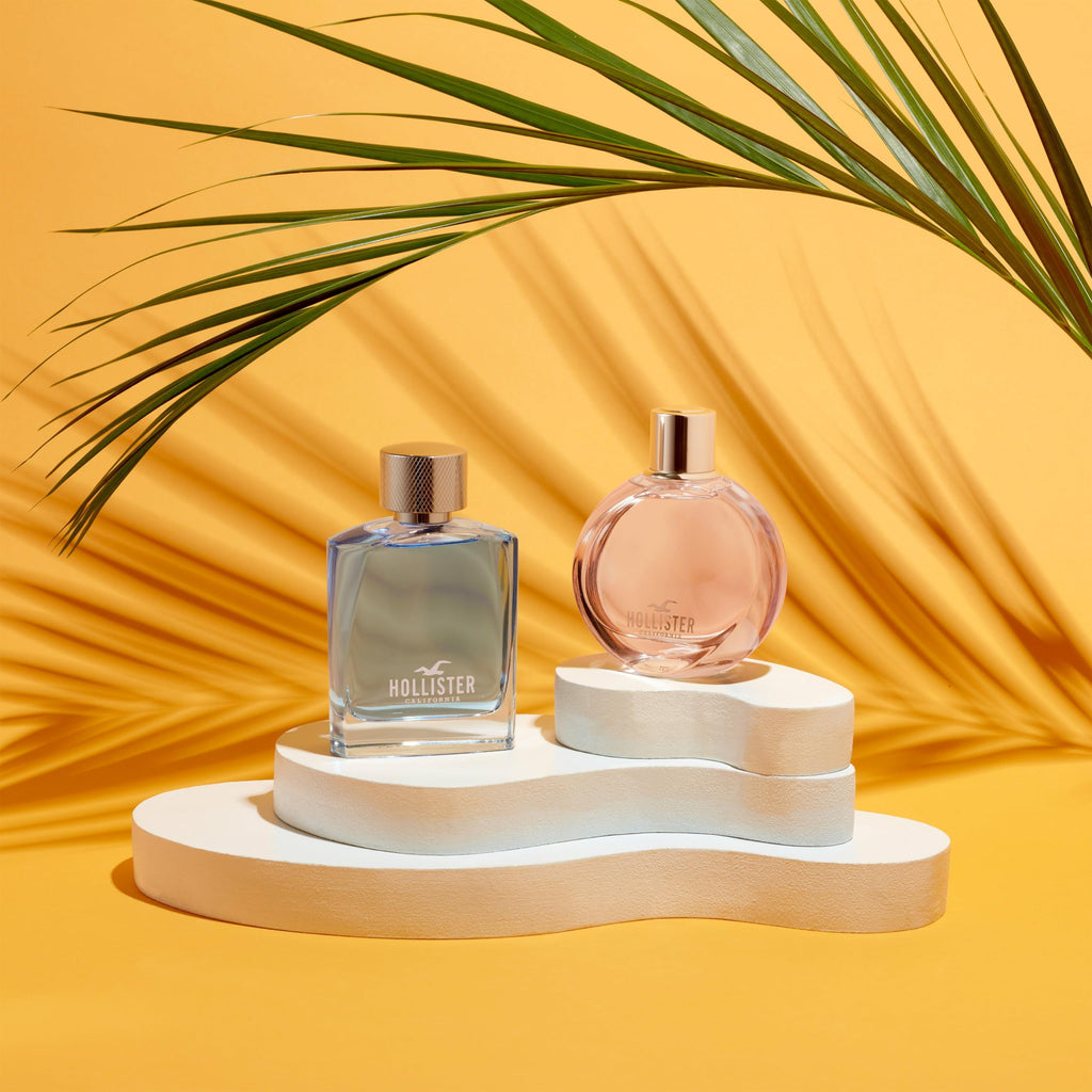Premium imported Hollister Wave Women Eau De Parfum, 3.4 oz, elegantly displayed with tropical elements.