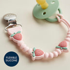 Discover the Itzy Ritzy Silicone Pacifier Clip, specially curated by Curat Cart, featuring charming strawberry designs for your little one.