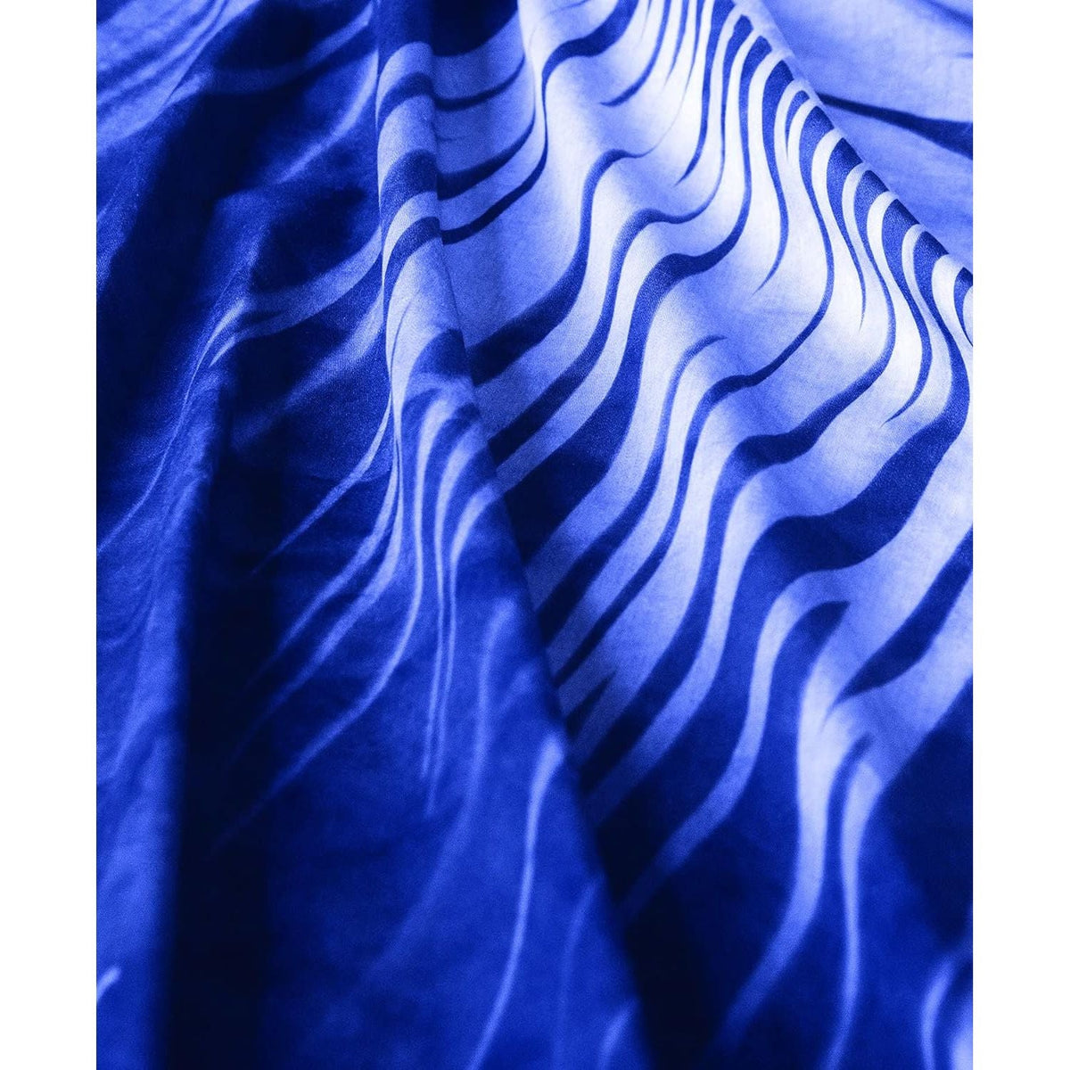 Discover the Jacquard Cyanotype Sensitizer Set, featuring striking wave patterns on deep blue fabric, perfect for creative projects.