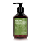 Jean & Len hand soap in a sleek amber pump bottle with green label, featuring lemon verbena and mint scent.