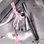 JUDYDOLL Waterproof Mascara-3D Curling T displayed elegantly with a silver bell and pink ribbon. Order online now, available in India.