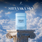 Khadlaj Shiyaaka Sky perfume displayed atop a classic column, surrounded by a beautiful blue sky.