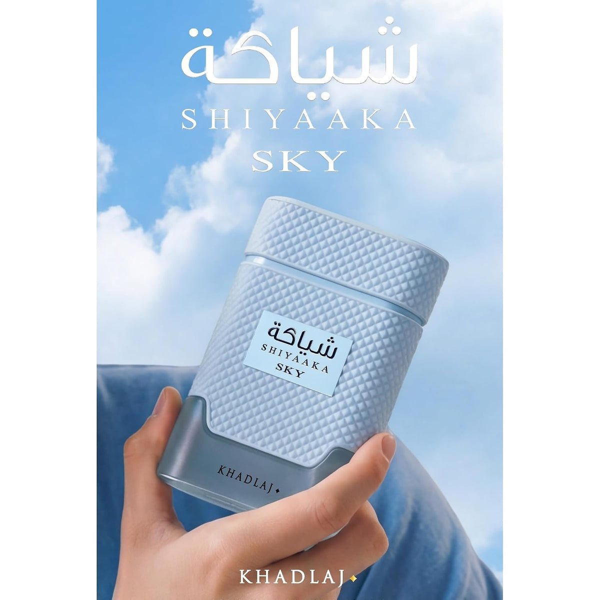 Authentic Khadlaj Shiyaaka Snow fragrance, featuring a light blue bottle held against a clear sky backdrop.