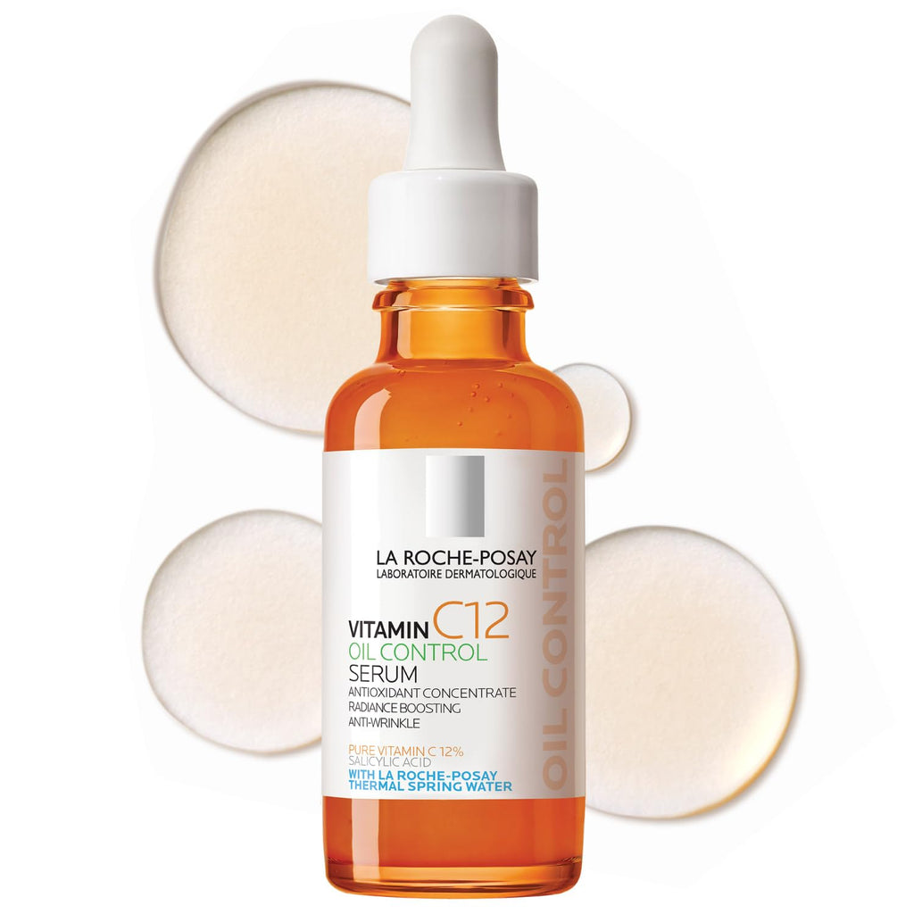 Authentic La Roche-Posay 12% Vitamin C Face Serum in a glass dropper bottle, with droplets of serum around it.