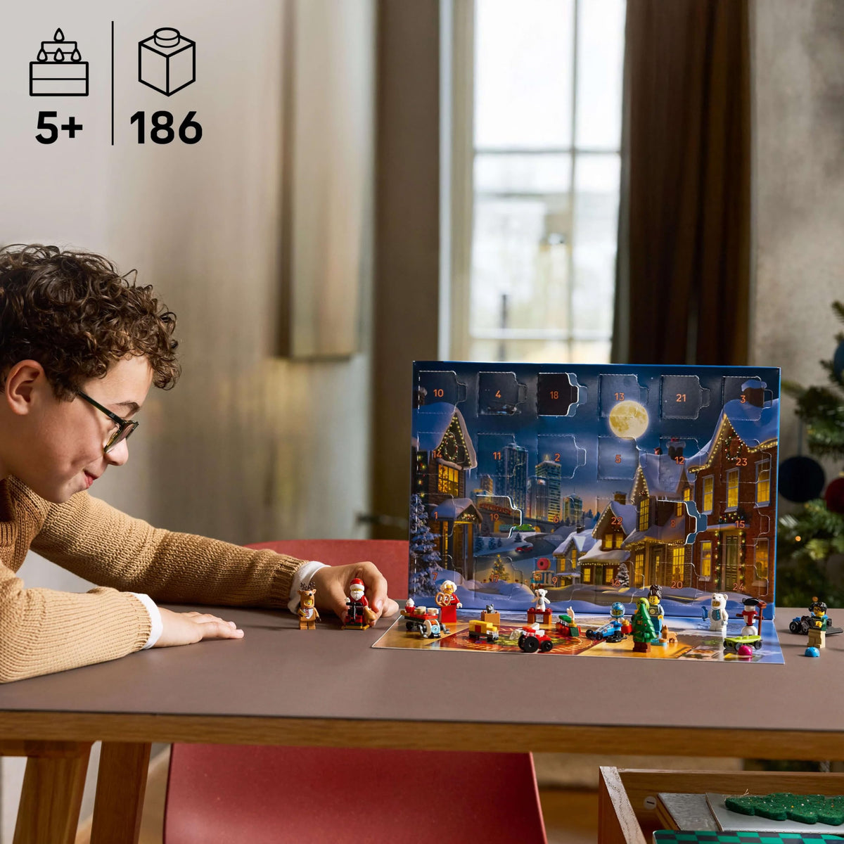 A child engages with the Disney Princess LEGO set, featuring festive scenes and 186 pieces. Premium imported fun for ages 5 and up.
