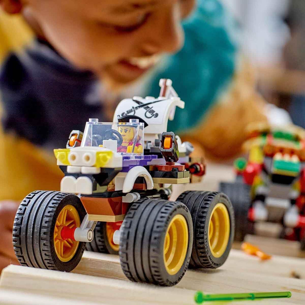 Kid building the Lego 60397 Monster Truck Race set, featuring a detailed truck with oversized tires, 301 pieces of fun.