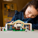 A child interacts with LEGO Animal Crossing Blathers's Museum, featuring animal figures and detailed exhibits. Verified by CuratCart.