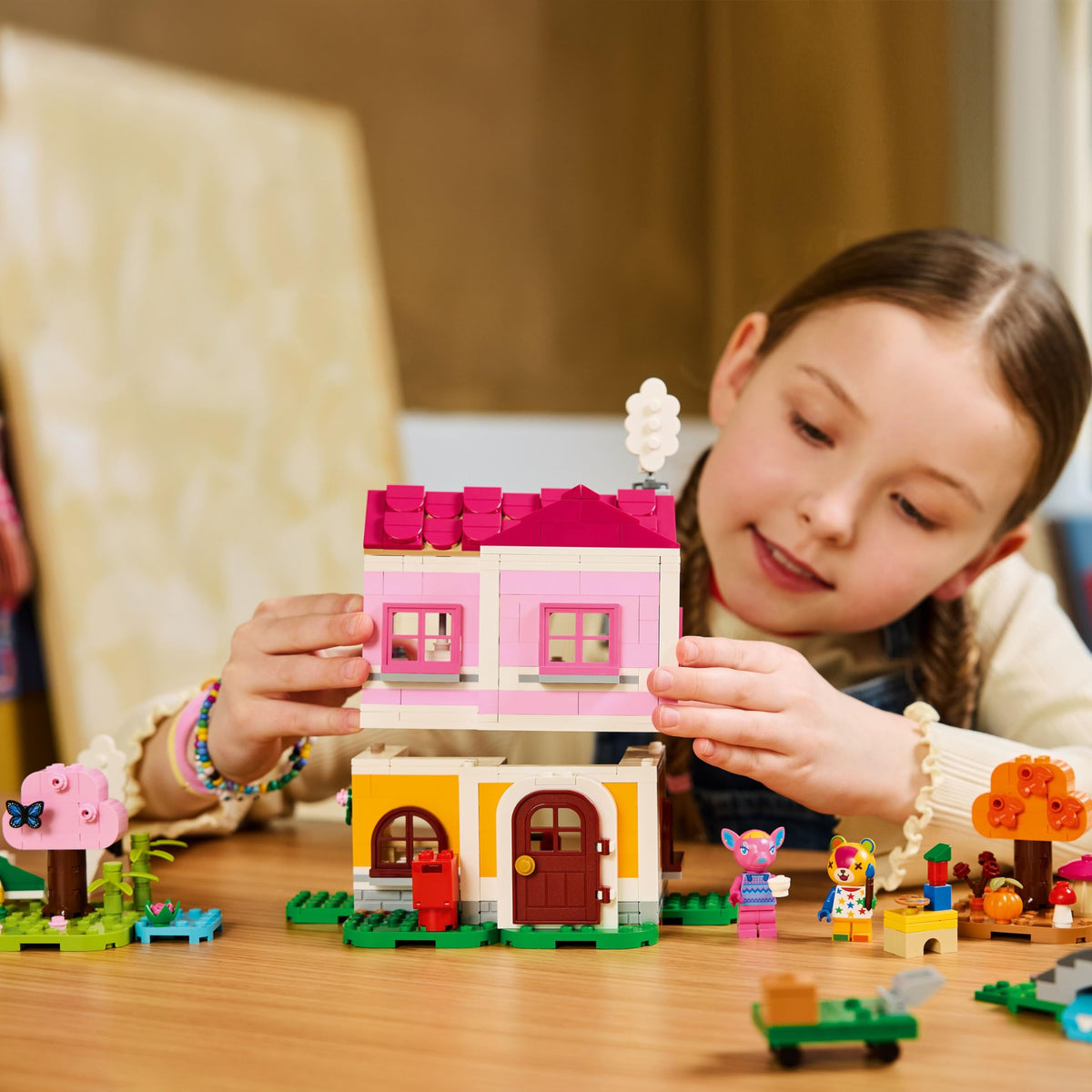 A girl constructs a vibrant LEGO house inspired by Animal Crossing, surrounded by fun mini figures and creative elements. Verified by CuratCart.
