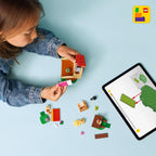 A child assembles LEGO Animal Crossing Goldie’s Cozy House set with colorful blocks and a tablet for guidance.