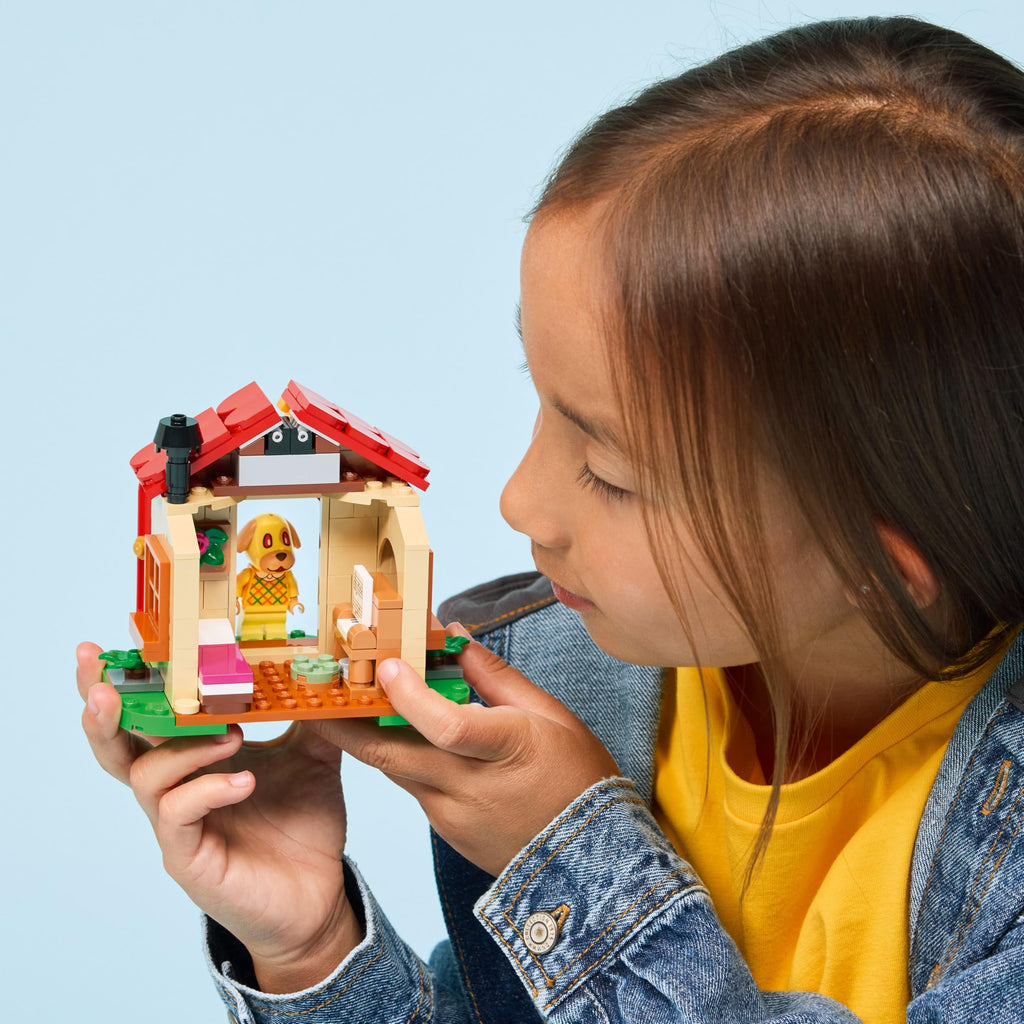A child showcases LEGO Animal Crossing Goldie's Cozy House, featuring detailed decor and play areas. Verified by CuratCart.