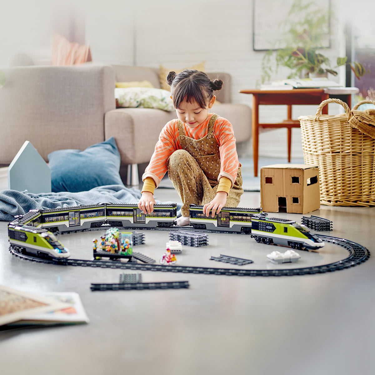 A child joyfully assembles the LEGO City Express Passenger Train Set. Available online in India. Order now!