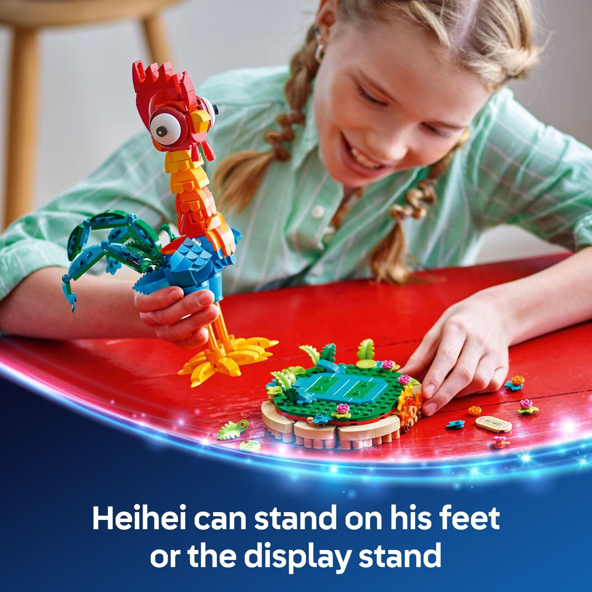 A child builds a vibrant LEGO Moana Heihei set, featuring Heihei and a display stand with tropical elements.