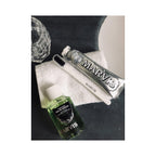 Marvis Strong Mint Mouthwash in high-quality packaging alongside toothbrush and toothpaste, available at Curat Cart.
