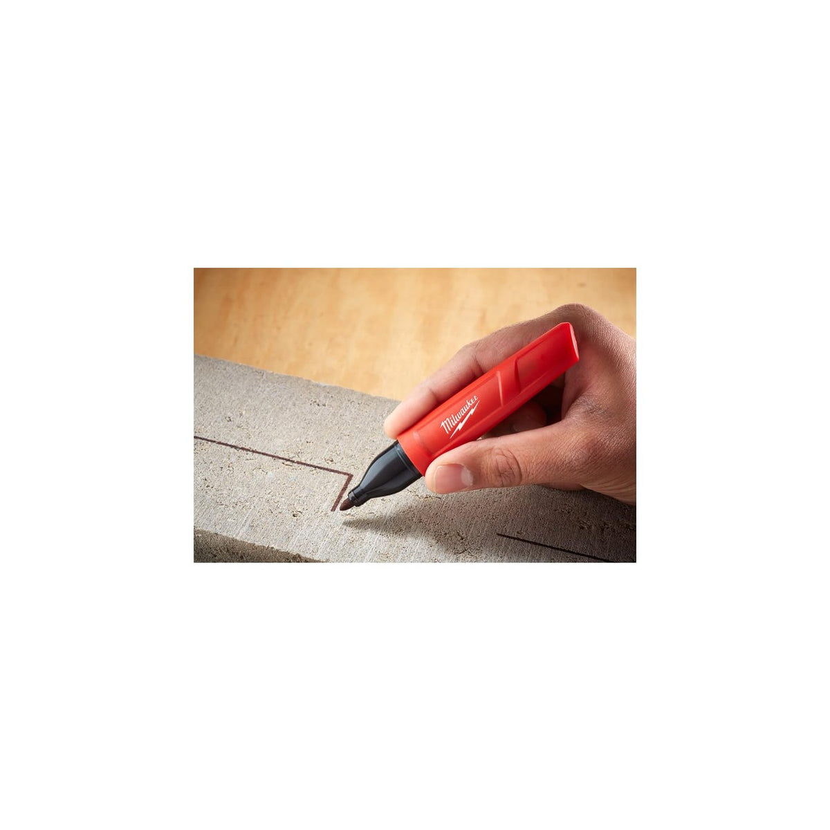 Milwaukee Inkzall Point Marker in hand, designed for precision marking on surfaces. Available at Curat Cart for quality performance.