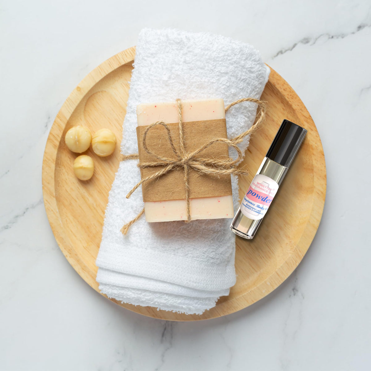 Discover the fresh scent of MOBETTER Fragrance Oils, elegantly presented with a handmade soap and soft towel for an indulgent experience.