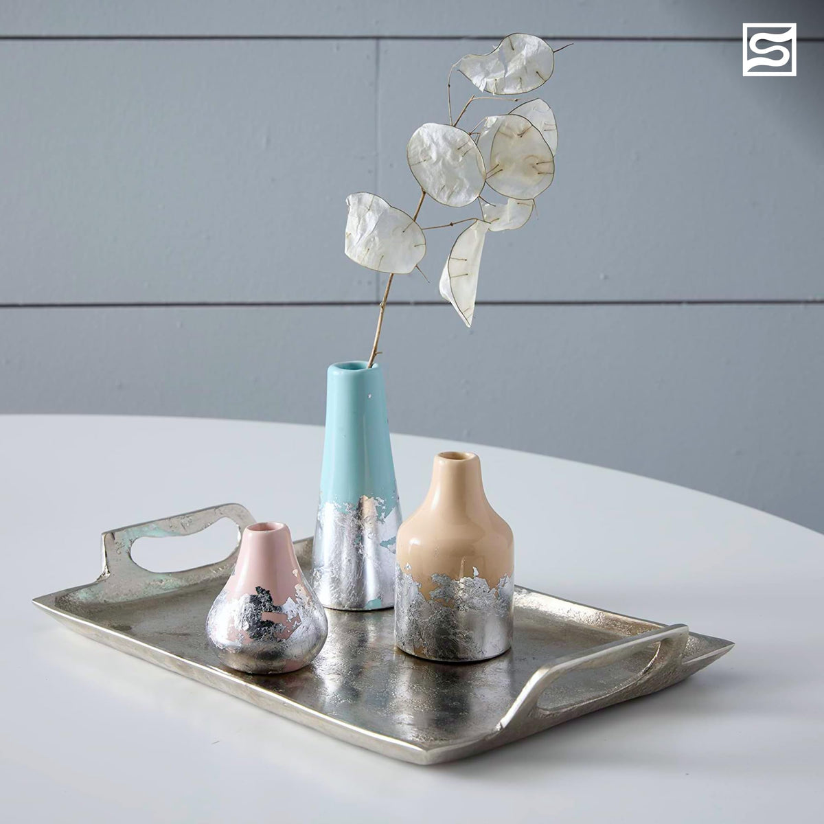 Mona Lisa Metal Leaf Adhesive showcased with decorative vases on a silver tray, highlighting premium quality at Curat Cart.