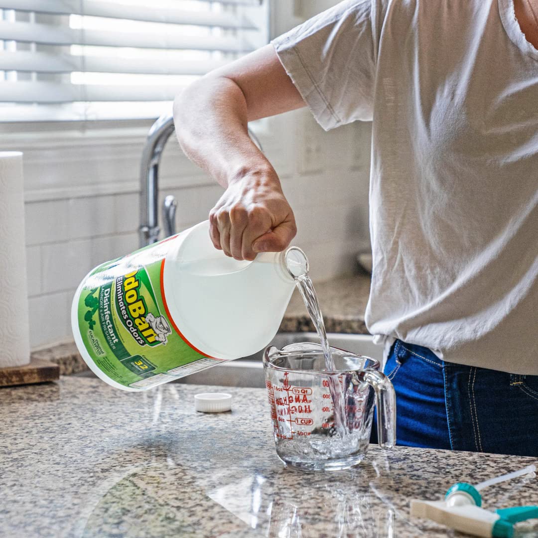 OdoBan Disinfectant Odor Eliminator being poured in a measuring cup, 100% Authentic and available at Curat Cart in India.