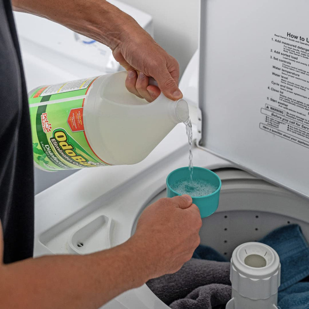 OdoBan Disinfectant Odor Eliminator poured into a cup, showcasing its high-quality packaging. Available at Curat Cart.