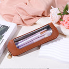 Stylish small clear makeup bag made of PU leather, featuring a zip closure and visible storage for beauty tools. Ideal for travel.