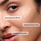 A close-up of a woman's face applying Revision Skincare Intellishade® Original. Broad-spectrum SPF 45, hydrates, and smoothes skin.