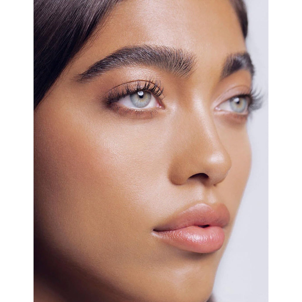 Beauty shot of a woman with glowing skin and defined brows. Verified by CuratCart for trust in RevitaLash products.