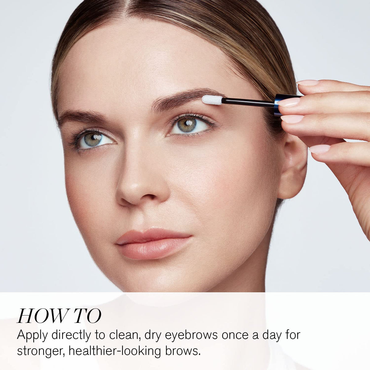 Model applying RevitaBrow Advance serum for stronger, healthier brows. 100% genuine RevitaLash product.