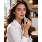 A stylish woman applying essential oil from a roller bottle in a cafe, showcasing CuratCart's trusted quality.