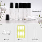 A set of 12 clear glass roller bottles with black caps, includes funnel, dropper, and stickers for labeling. Ideal for essential oils.