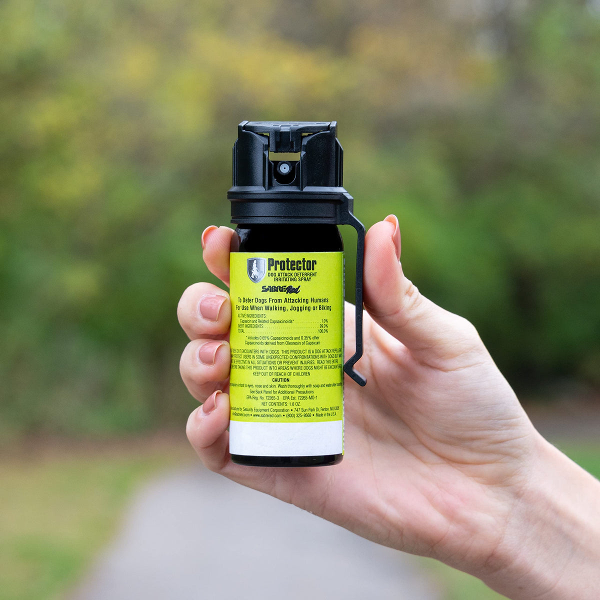 SABRE Protector Dog Pepper Spray in hand, 100% Authentic, available in India at Curat Cart. Effective personal safety tool.
