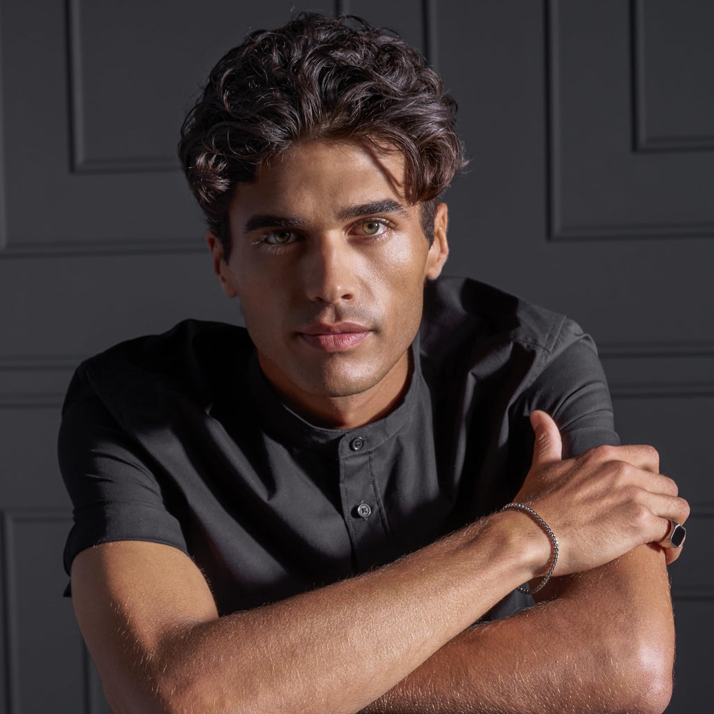 A man poses confidently, highlighting the hair product 'SexyHair Style Frenzy Matte Texturizing' with original packaging.