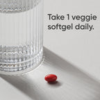 Premium Sports Research Pure Saffron veggie softgel beside a clear glass. High-quality packaging available at Curat Cart.