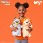 Child happily holding two Squishmallows Bluey plush toys. Order this cute cuddly toy online, available now!