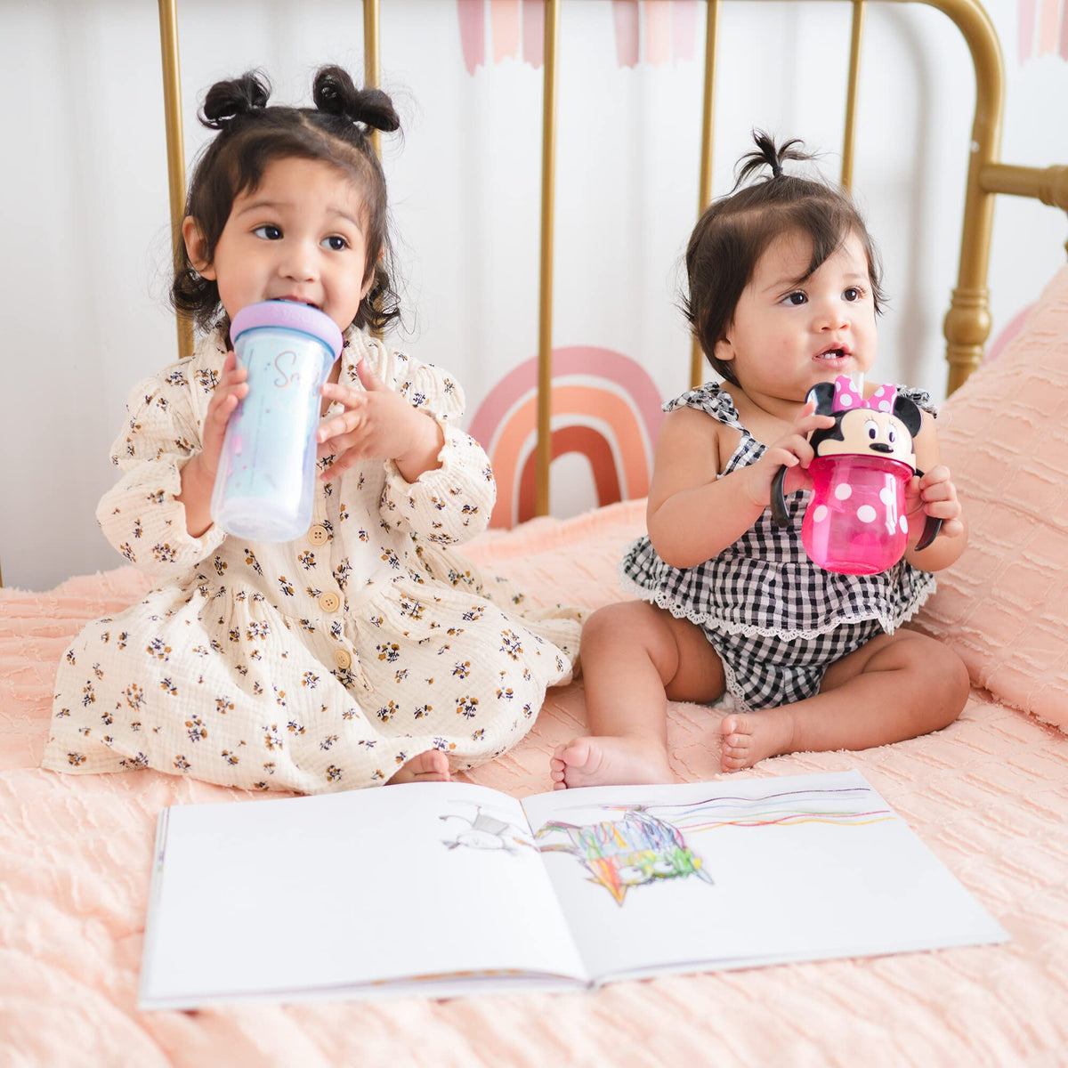 Two happy toddlers enjoying their Disney Minnie Mouse Trainer Cup. Verified by CuratCart for quality assurance.
