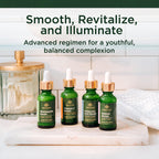 Four Tree of Life serums for skin care, including Vitamin C and Retinol, in elegant green bottles on a marble surface.