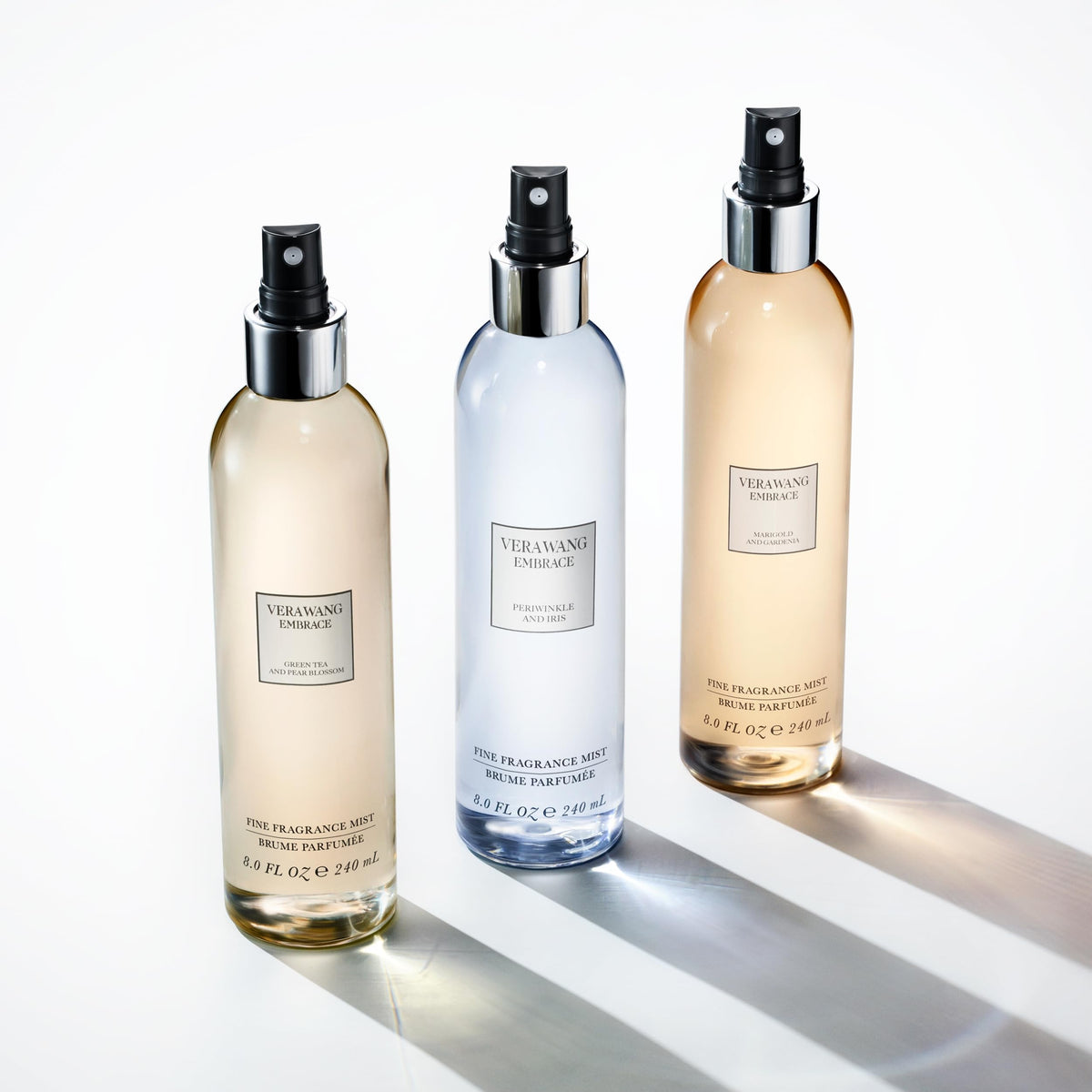 Three bottles of Vera Wang Embrace fragrances, including Green Tea and Pear Blossom, showcasing authenticity and elegance.