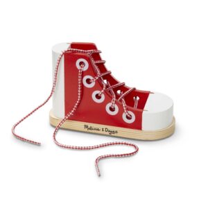 Discover the authentic Melissa & Doug Lacing Sneaker, a charming red wooden toy designed for fun and skill-building.